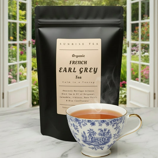 Black tea package labeled 'French Earl Grey' with a teacup and teapot on a blurred green background