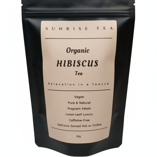 Black tea bag with 'Sunrise Tea' label on a white background