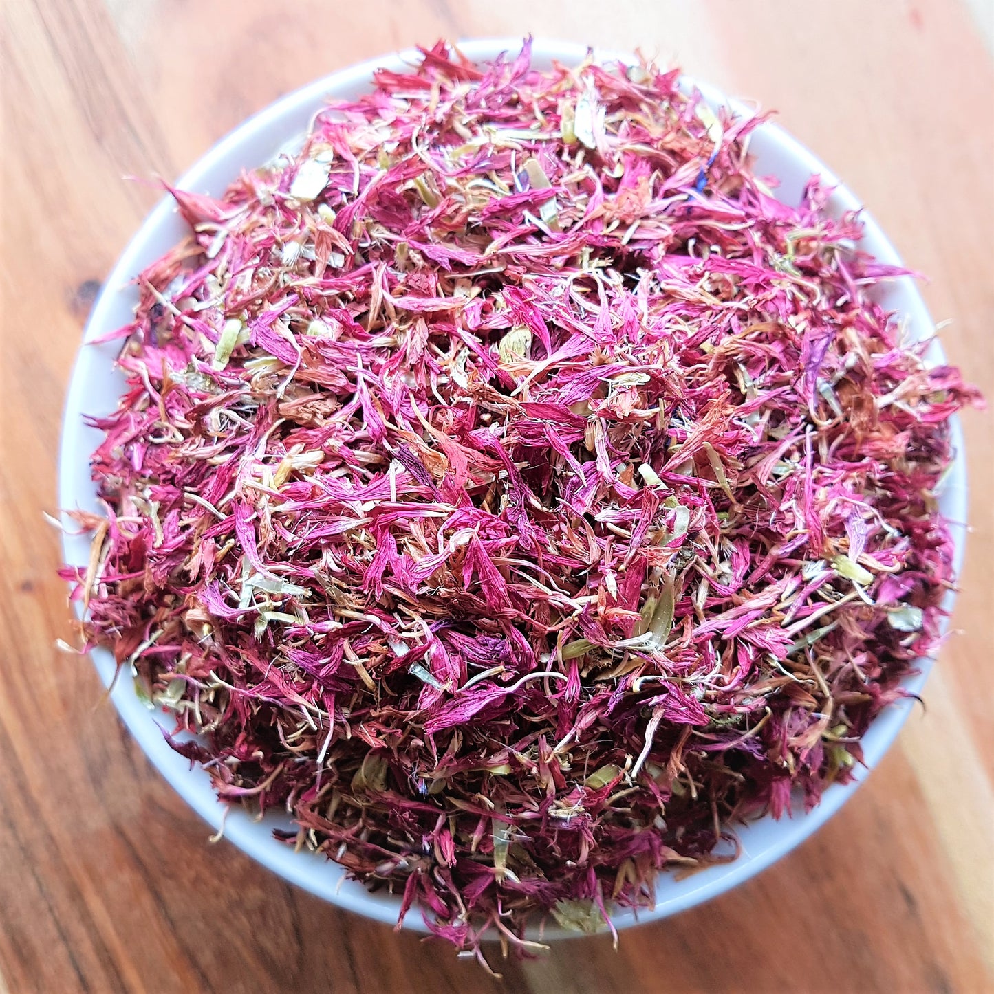 purple or pink cornflowers dried in white bowl