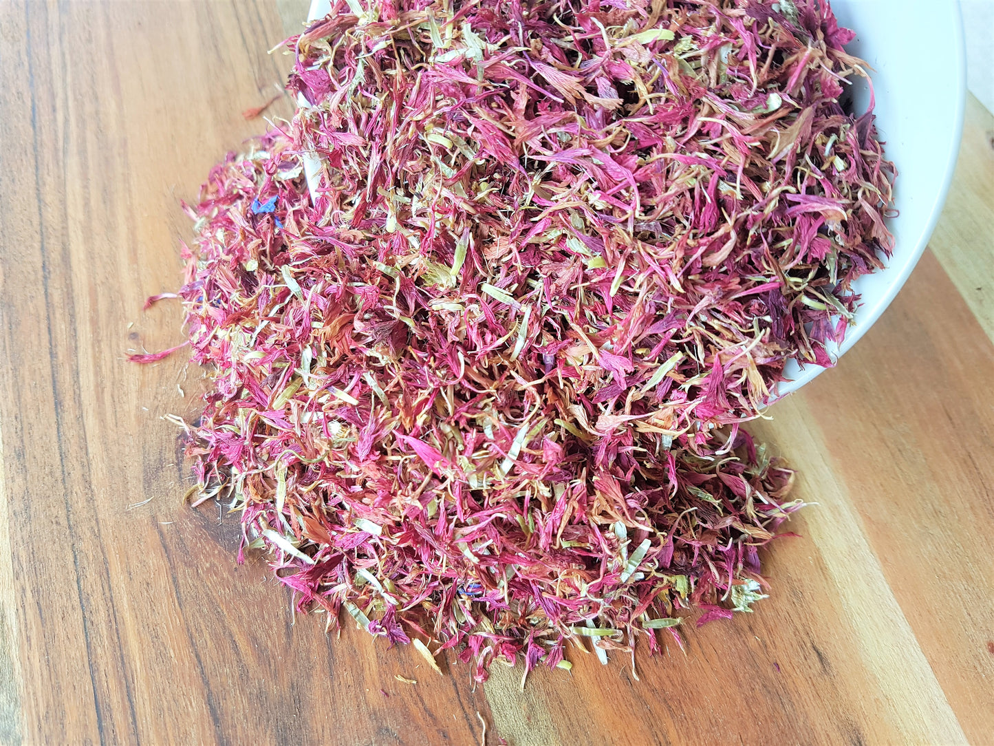 purple or pink cornflowers spilling out of bowl