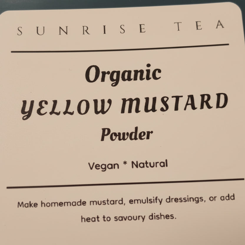 Label for Organic Yellow Mustard Powder by Sunrise Tea on a dark surface