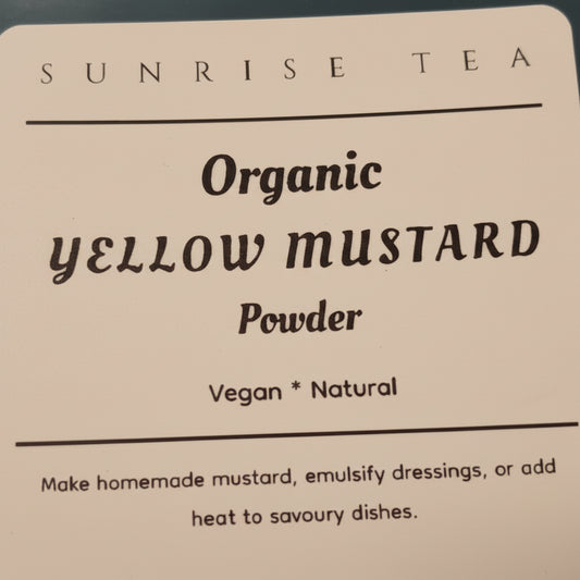 Label for Organic Yellow Mustard Powder by Sunrise Tea on a dark surface