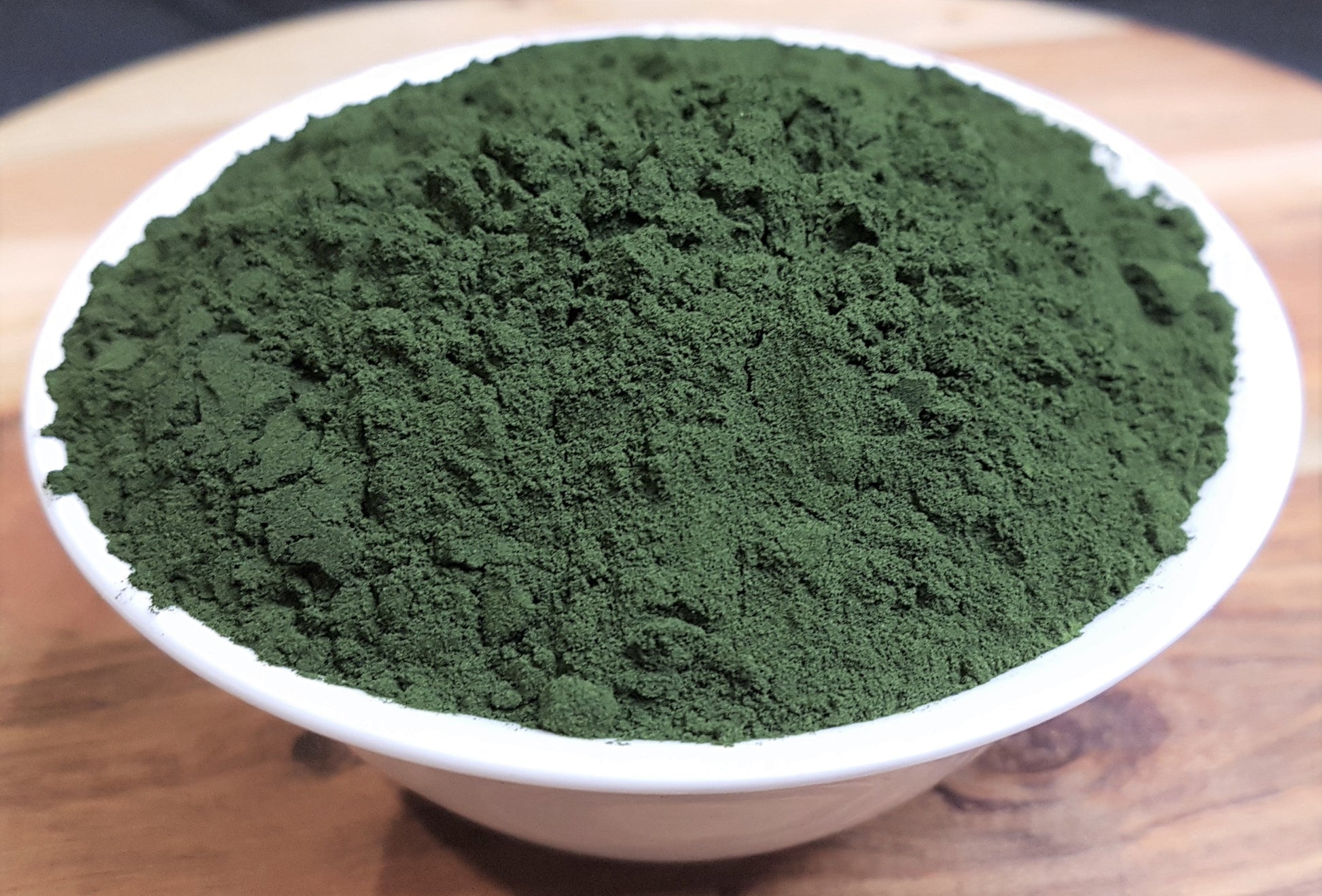 organic chlorella powder in bowl close up