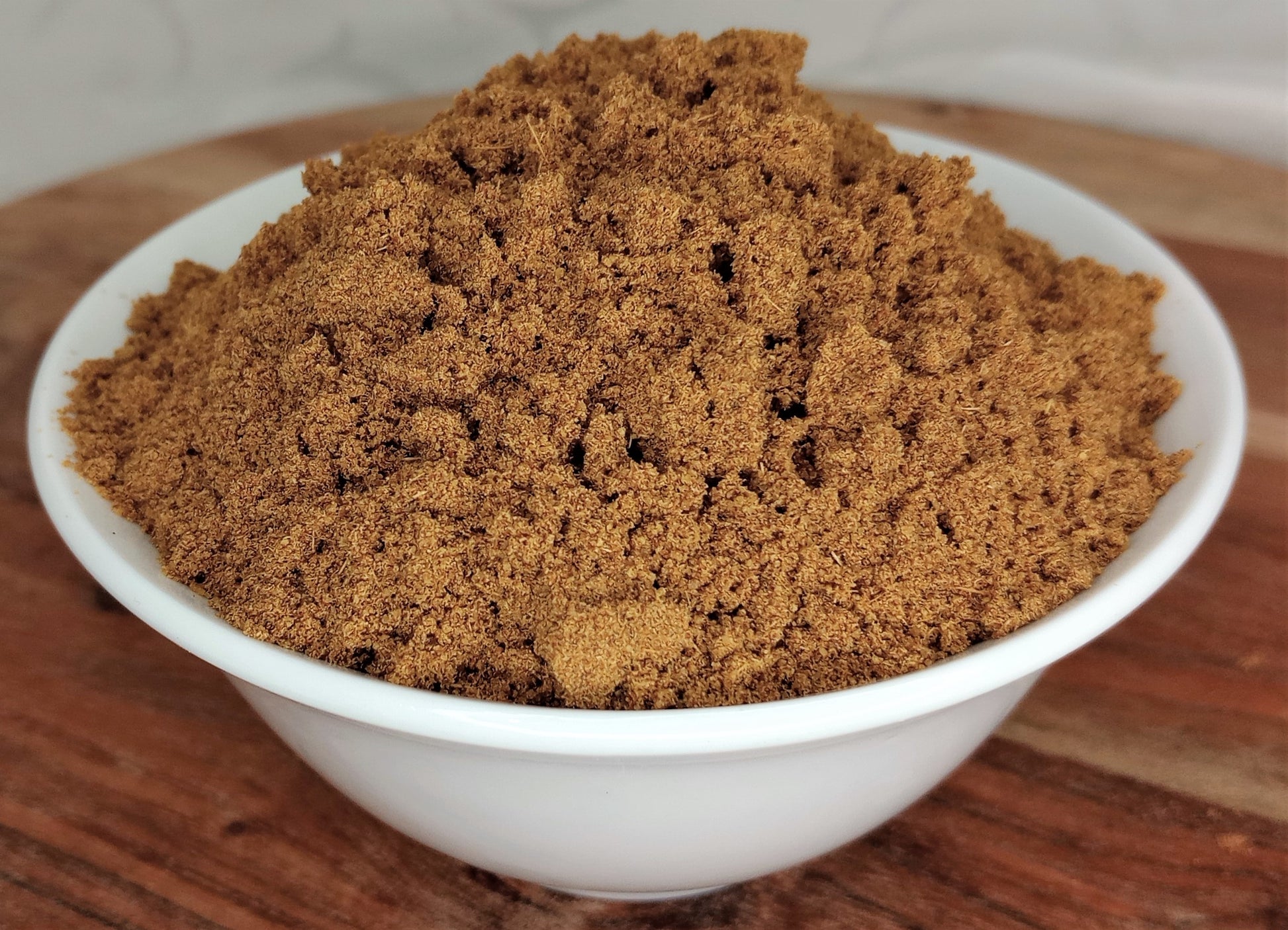 organic cumin powder in bowl