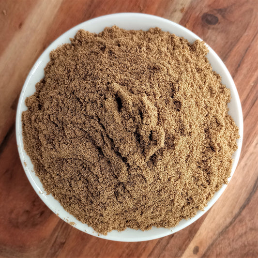 caraway seed powder in white bowl