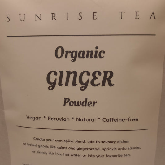 Package of Sunrise Tea Organic Ginger Powder on a brown background