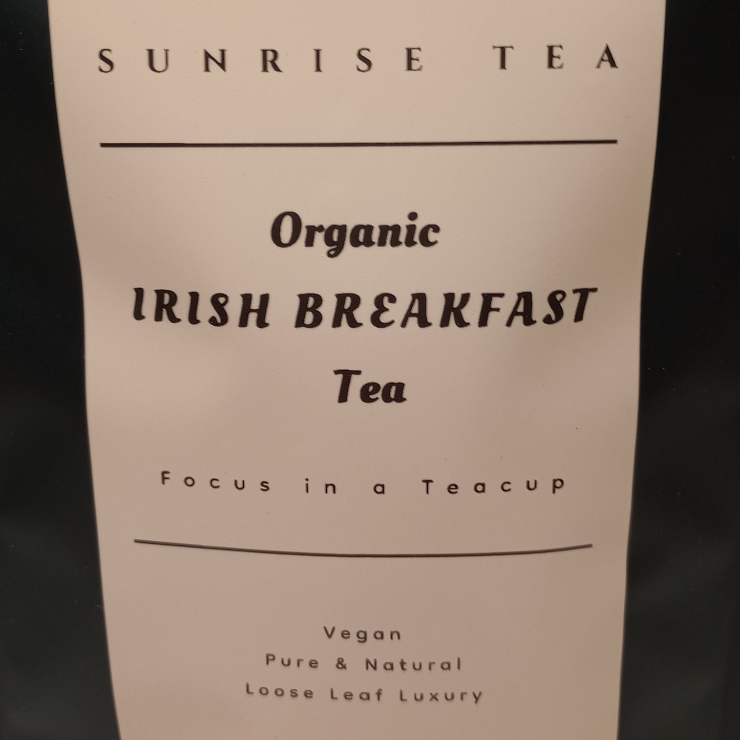 Tea package with 'Sunrise Tea' label on a plain background