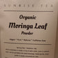 Bag of Organic Moringa Leaf Powder with 'Sunrise Tea' branding on a white background