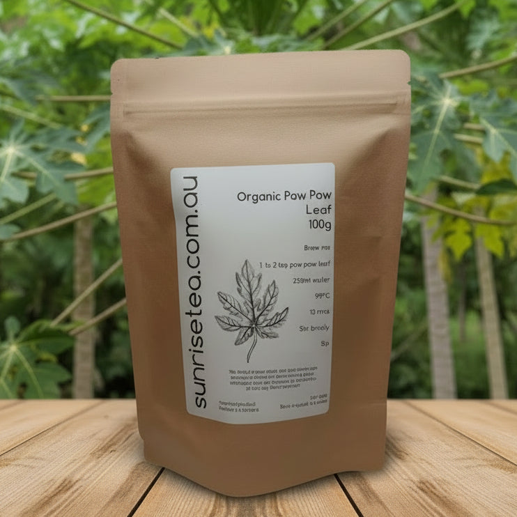 Brown package of Organic Paw Paw Leaf with a label on a wooden surface and green leafy background