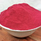 organic beetroot powder in a bowl in a deep red colour