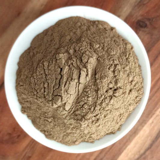 organic black pepper powder in a white bowl