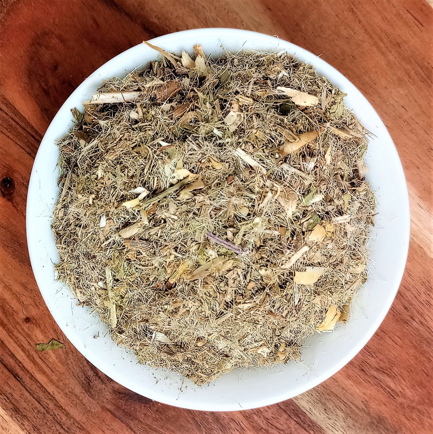 organic dried blessed thistle herb in a white bowl