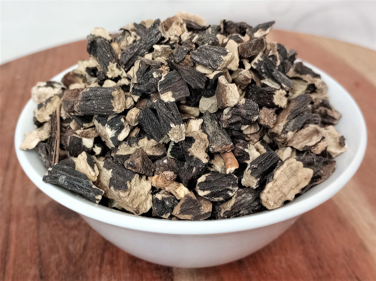 organic comfrey root in bowl close up
