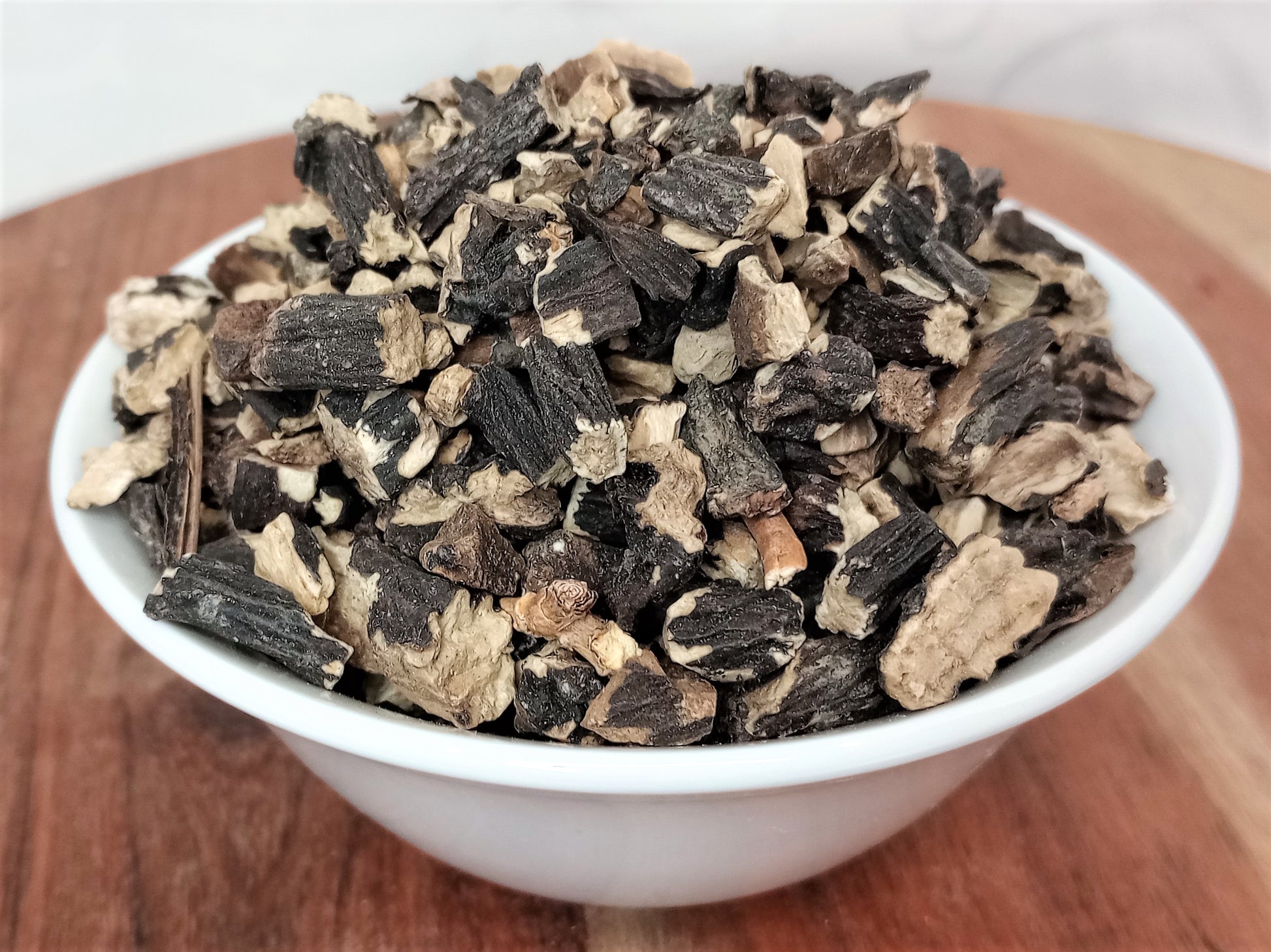 organic comfrey root in bowl close up