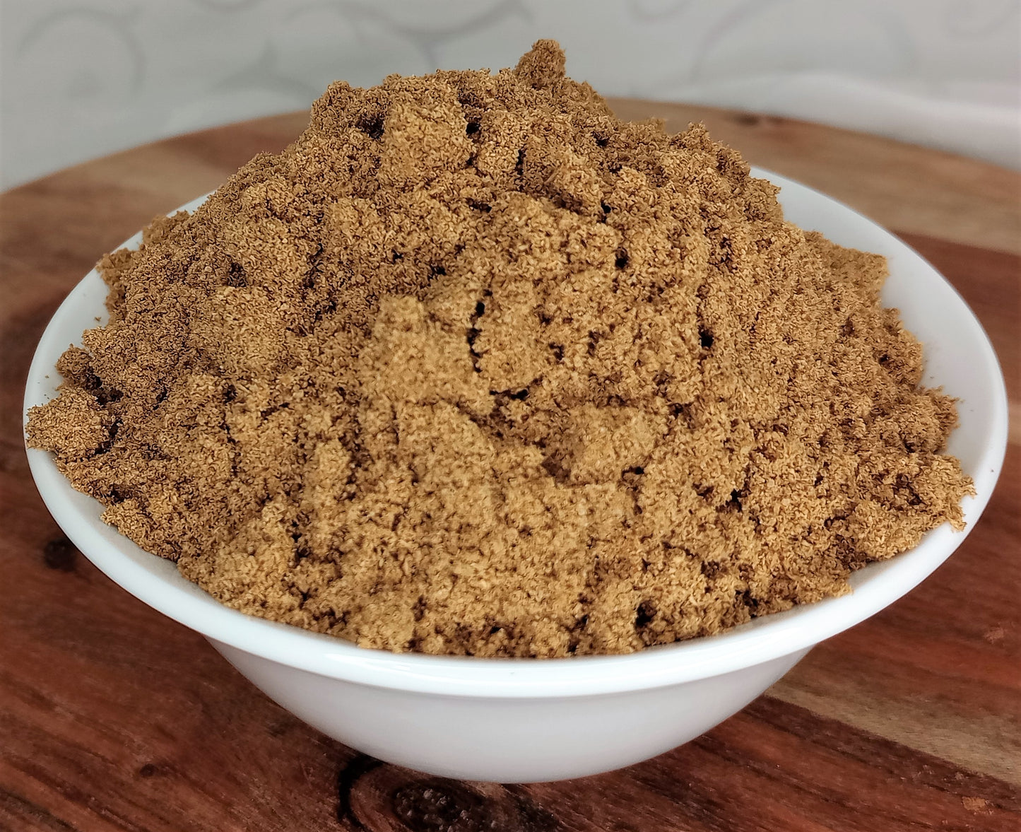 organic coriander powder in bowl close up