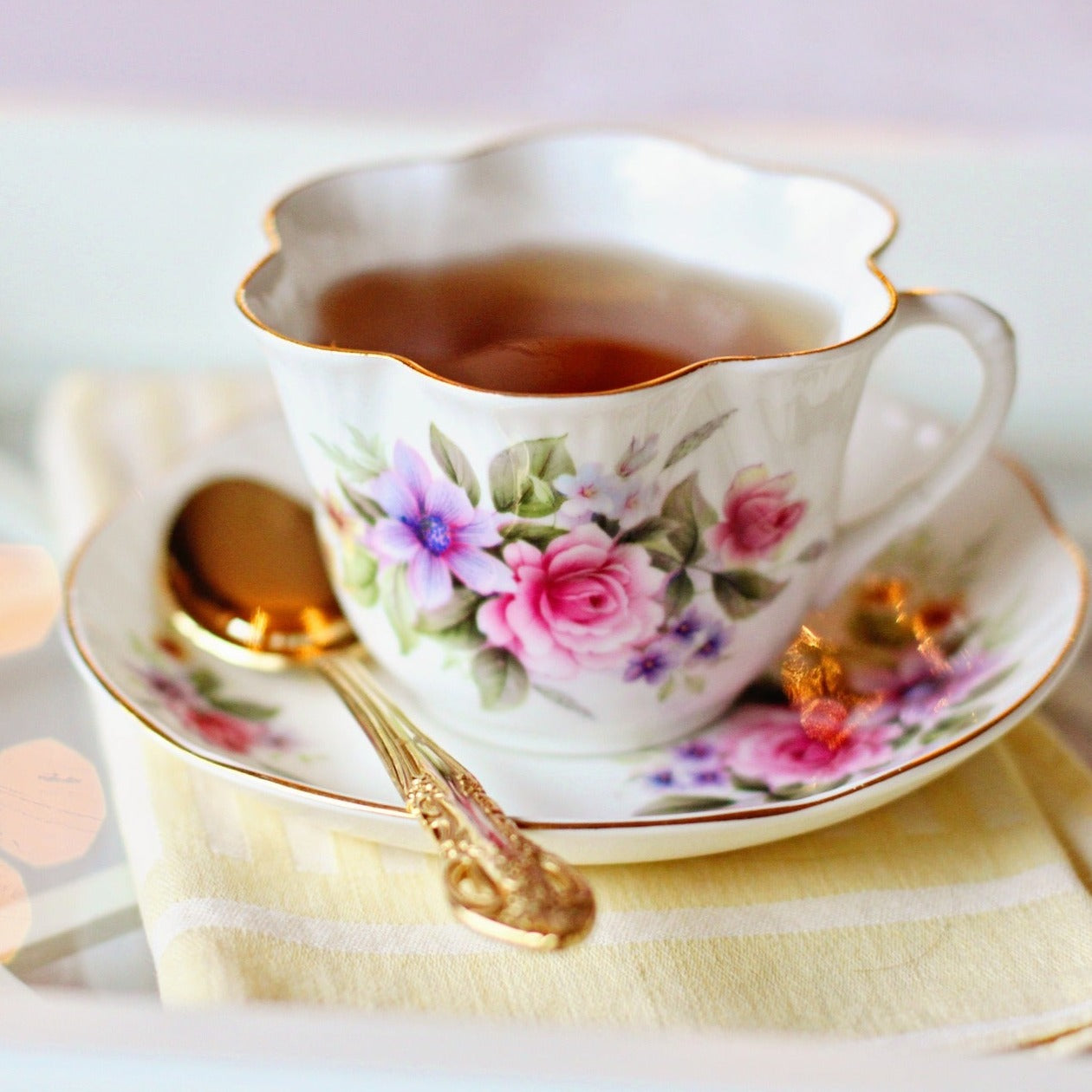 Rosehip tea in a floral teacup with a unique flower shaped opening.