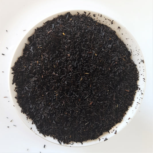 Earl grey tea leaves in a white bowl