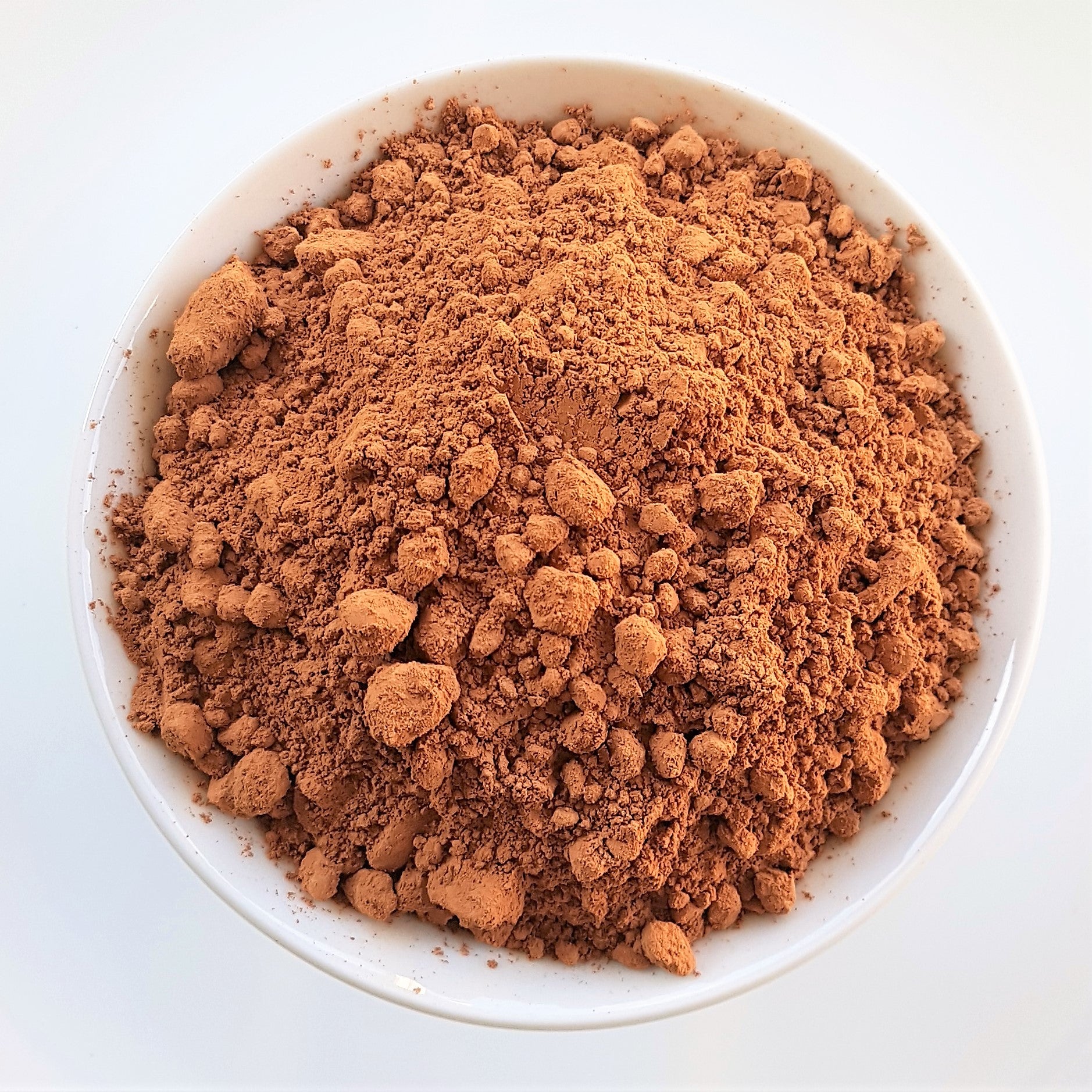 organic cacao powder in bowl raw