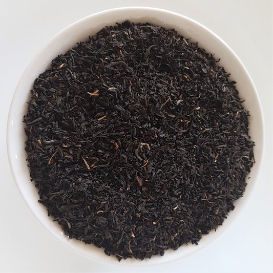 Pile of black loose leaf tea with white background. Benefits of black tea include being packed with antioxidants. Can help boost heart health, lower risk of cancer, blood sugar levels, bad cholesterol, risk of stroke, etc.